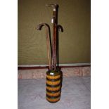 GERMAN GREEN AND OCHRE GLAZED POTTERY VASE CONTAINING TWO ASSORTED WALKING CANES AND A HORN