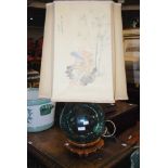 GREEN TINTED GLASS FLOAT CONVERTED TO A TABLE LAMP WITH PAINTED SILK SHADE ON CARVED WOOD STAND,