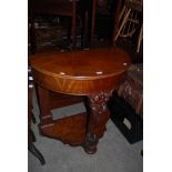 A VICTORIAN MAHOGANY DEMI LUNE CONSOLE TABLE ON FOLIATE CARVED SUPPORT