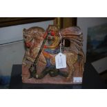 A CARVED AND PAINTED WOODEN FIGURE OF ST GEORGE SLAYING THE DRAGON