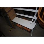 A WHITE PAINTED SLATTED WOOD GARDEN BENCH WITH BRANCH FORM CAST IRON ENDS