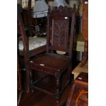 AN EARLY 20TH CENTURY SCOTTISH OAK CHILDS CHAIR WITH THISTLE CARVED PANEL BACK, THISTLE CARVED
