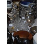 THREE ASSORTED GLASS DECANTERS AND STOPPERS, EACH WITH SILVER LABELS - WHISKY, BRANDY AND SHERRY,