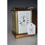 LACQUERED BRASS CARRIAGE CLOCK WITH WHITE ROMAN NUMERAL DIAL