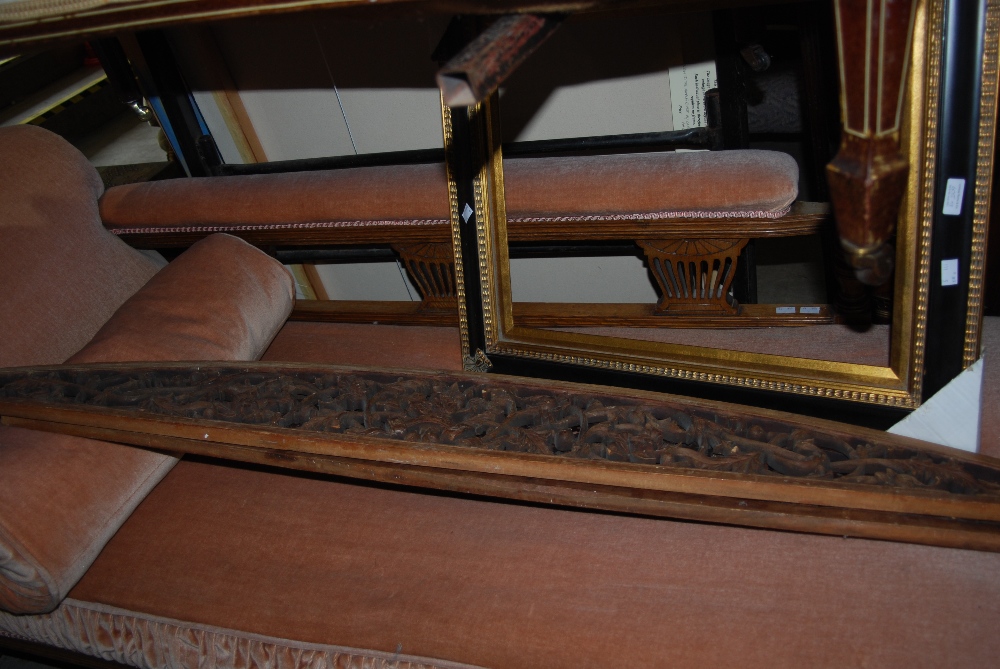 TWO PIERCED AND FOLIATE CARVED DOOR PEDIMENTS AND A BLACK AND GILT DECORATIVE PICTURE FRAME