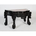 A Chinese dark wood console table, Qing Dynasty, the serpentine top with mottled red and white