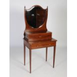 An Edwardian mahogany and satinwood banded dressing table, the upright back with shield-shaped