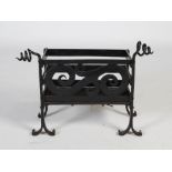 An Arts & Crafts wrought iron fire basket, of rectangular form with scroll detail to the front,