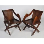 A pair of oak Arts & Crafts Glastonbury chairs, with rectangular panel backs and solid seats