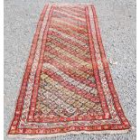A Persian runner, late 19th century, the earth brown coloured rectangular field decorated with