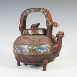 A Chinese bronze and champleve enamel kettle and cover, Qing Dynasty, decorated in relief with