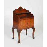 An early 20th century walnut side cabinet, the rectangular top with open shelf and shell carved