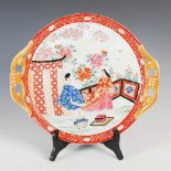A Japanese Imari twin handled circular tray, late 19th/ early 20th century, decorated with fenced