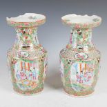 A pair of Chinese porcelain famille rose Canton vases, Qing Dynasty, decorated with oval shaped