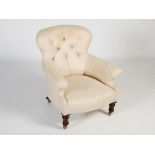 A 19th century walnut armchair, the button upholstered back and arms with stuff-over seat raised