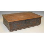 An antique Bible box, the hinged rectangular top above a frieze carved with two stylised birds and