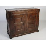 A 19th century oak side cabinet, the rectangular top with moulded edge above a frieze with moulded