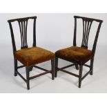 A pair of George III mahogany chip-carved side chairs, the flat top rails with scroll detail above