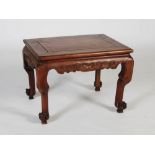 A Chinese dark wood Kang table, late 19th/ early 20th century, the rectangular panelled top above