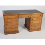 A Victorian blonde oak pedestal desk, the rectangular top with green leather skiver insert above