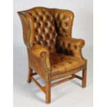 A mid/ late 20th century leather upholstered Chesterfield wing armchair, with button-down