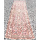 A Persian long rug and a Persian runner, the long rug with a blue rectangular field of stylised