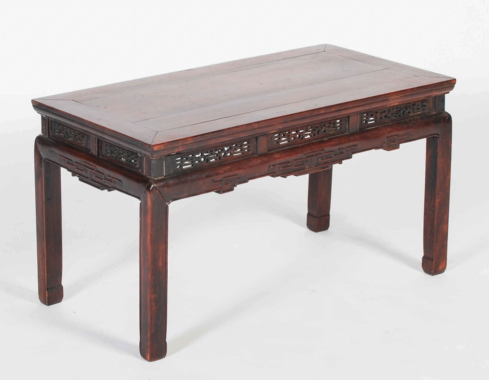 A Chinese dark wood Kang table, Qing Dynasty, the rectangular panelled top above a frieze set with