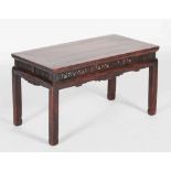 A Chinese dark wood Kang table, Qing Dynasty, the rectangular panelled top above a frieze set with