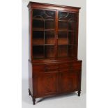 A George III mahogany bookcase, the moulded cornice above a pair of astragal glazed cupboard doors