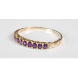 A Victorian style 9ct gold amethyst and diamond set half hoop bangle, set with a single line of nine