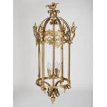 A late 19th/ early 20th century brass four light hanging lantern, with scroll, ring and foliate cast