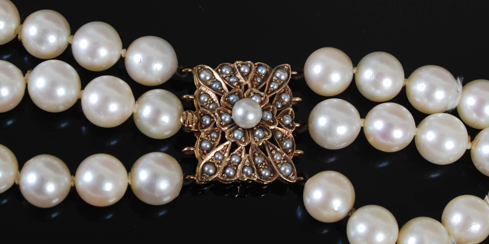 A cultured pearl necklet with 9ct gold and pearl set clasp, triple matinee length rows of forty- - Image 2 of 5