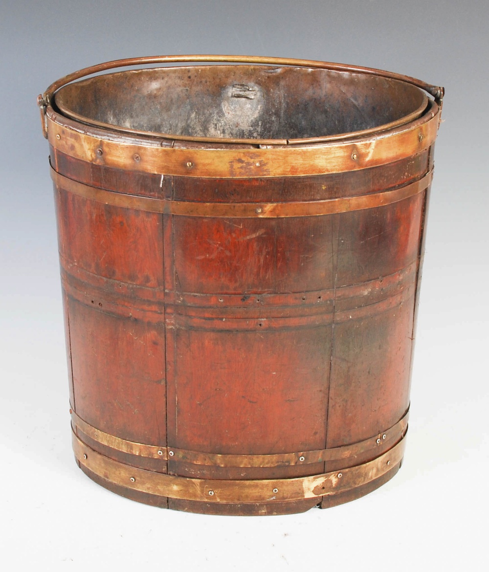A 19th century mahogany and brass bound oval pail, with hinged carry handle, 34cm high x 34cm wide. - Image 2 of 5