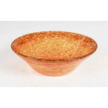 A Monart bowl, shape MC, mottled dark to light orange and yellow glass, bearing original paper