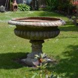 A 19th century fire clay garden urn of campagna form, in two sections, 104cm diamter x 82cm high.
