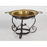 A late 19th century Eastern brass two-handled bowl on wrought iron stand, 50cm diameter x 41cm