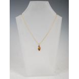 MISTRAL DESIGN, A 9ct yellow gold pendant, set with a faceted pointed oval citrine, on 9 carat