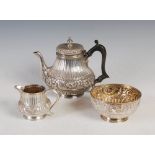 A late Victorian three piece silver tea set, London, 1896 and later, makers mark of HB, of fluted