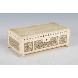 A 19th century European ivory casket, the hinged cover with a rectangular field enclosing tracery