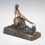 E. Worner, bronze figure group of female sitting on a snail, signed in the bronze 'E. Worner',