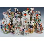 A collection of twenty-three Staffordshire flatback pottery figures, to include; 'DOG TRAV', 30cm