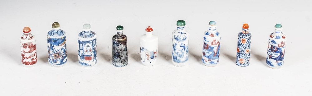 A collection of nine Chinese blue, white and copper red porcelain snuff bottles, to include; a