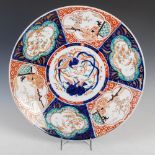 A Japanese Imari charger, late 19th/ early 20th century, the central roundel decorated with long
