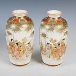 A pair of Japanese Satsuma pottery vases, Meiji Period, decorated with Bijan and children in a