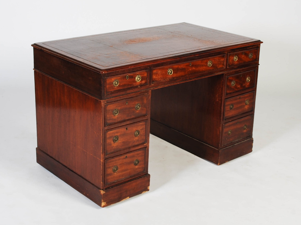 A 19th century mahogany pedestal desk, the rectangular top with claret coloured skiver above a