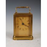 A 19th century lacquered brass carriage clock, with Roman numeral dial and bevelled glass panels, in