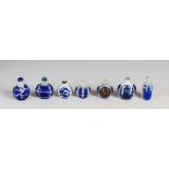 A collection of seven Chinese blue glass overlay snuff bottles, Qing Dynasty and later, to