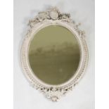 A late 19th century later painted giltwood oval wall mirror, with oval portrait medallion and ribbon