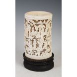 A Chinese ivory tusk vase, Qing Dynasty, carved with figures, pavilions and pine trees on a