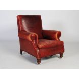 A late 19th century burgundy leather upholstered club armchair, the rectangular back and scroll arms